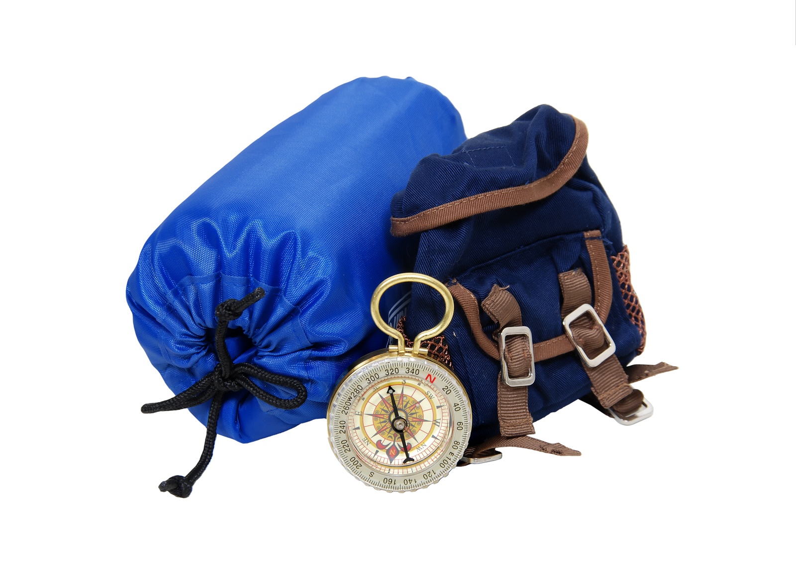 Backpack with rolled up sleeping bag and compass for overnight trips - path included