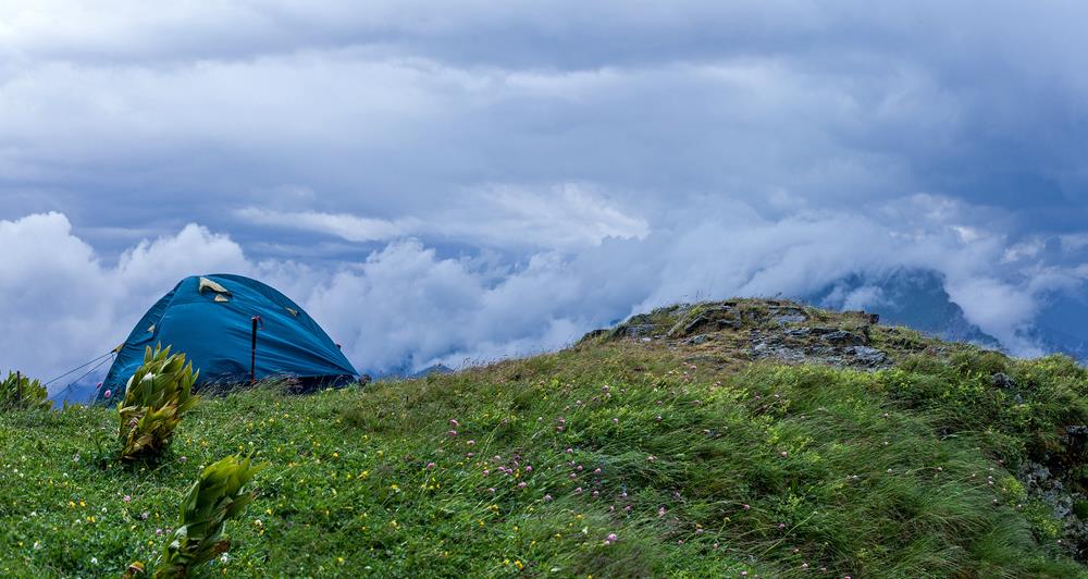 Tent, blown away by the wind, in the mountains