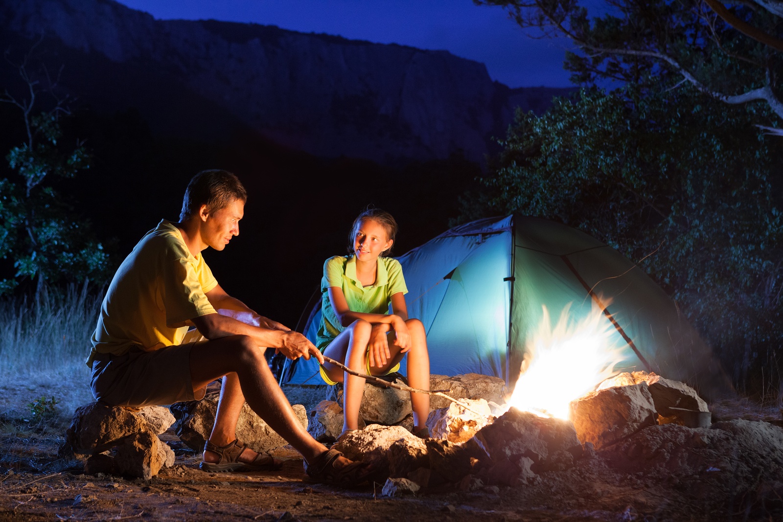 Couple in camping with campfire at night