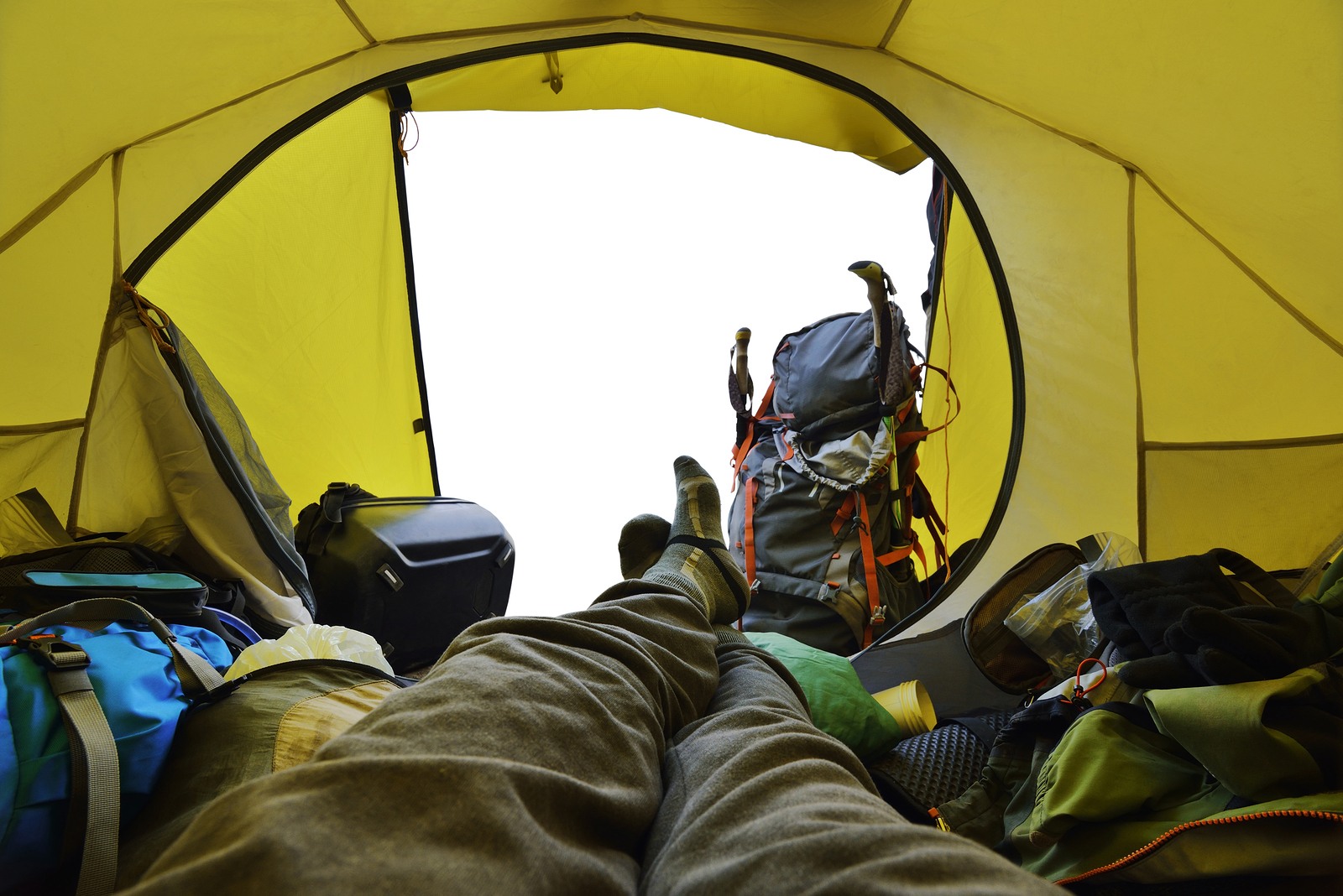 Traveler lying down in the tent with white view from in tent